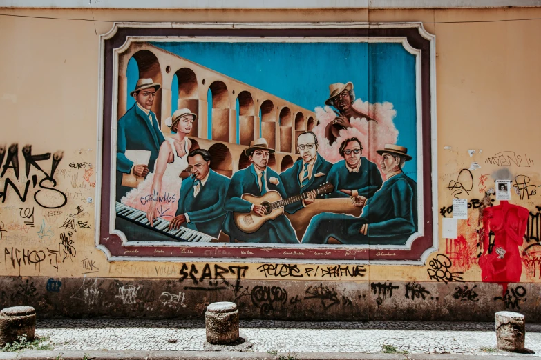 a wall covered in graffiti and a poster of a band on it