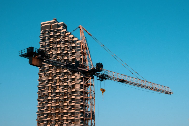 a crane is lifting some sort of material onto a skyscr