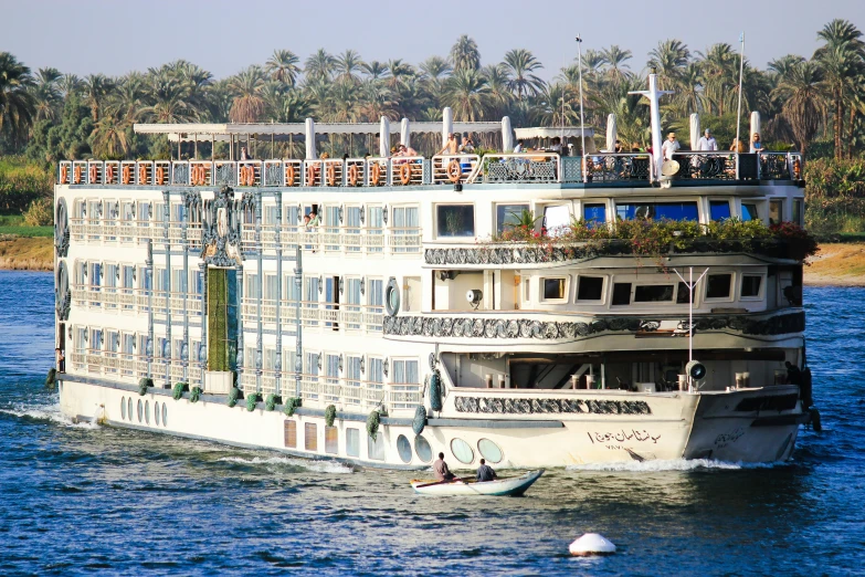 a cruise ship sailing through the water with people in it