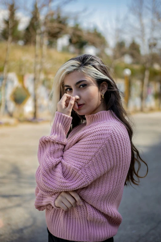 a young woman with an unusual make up talking on the phone