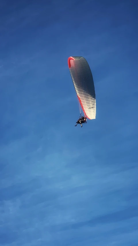 a person windsurfing in the air on a clear day