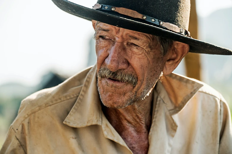 an older man with gray hair wearing a hat