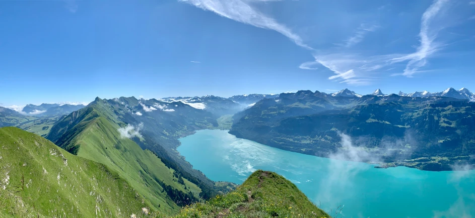 an expansive lake surrounded by a green hill