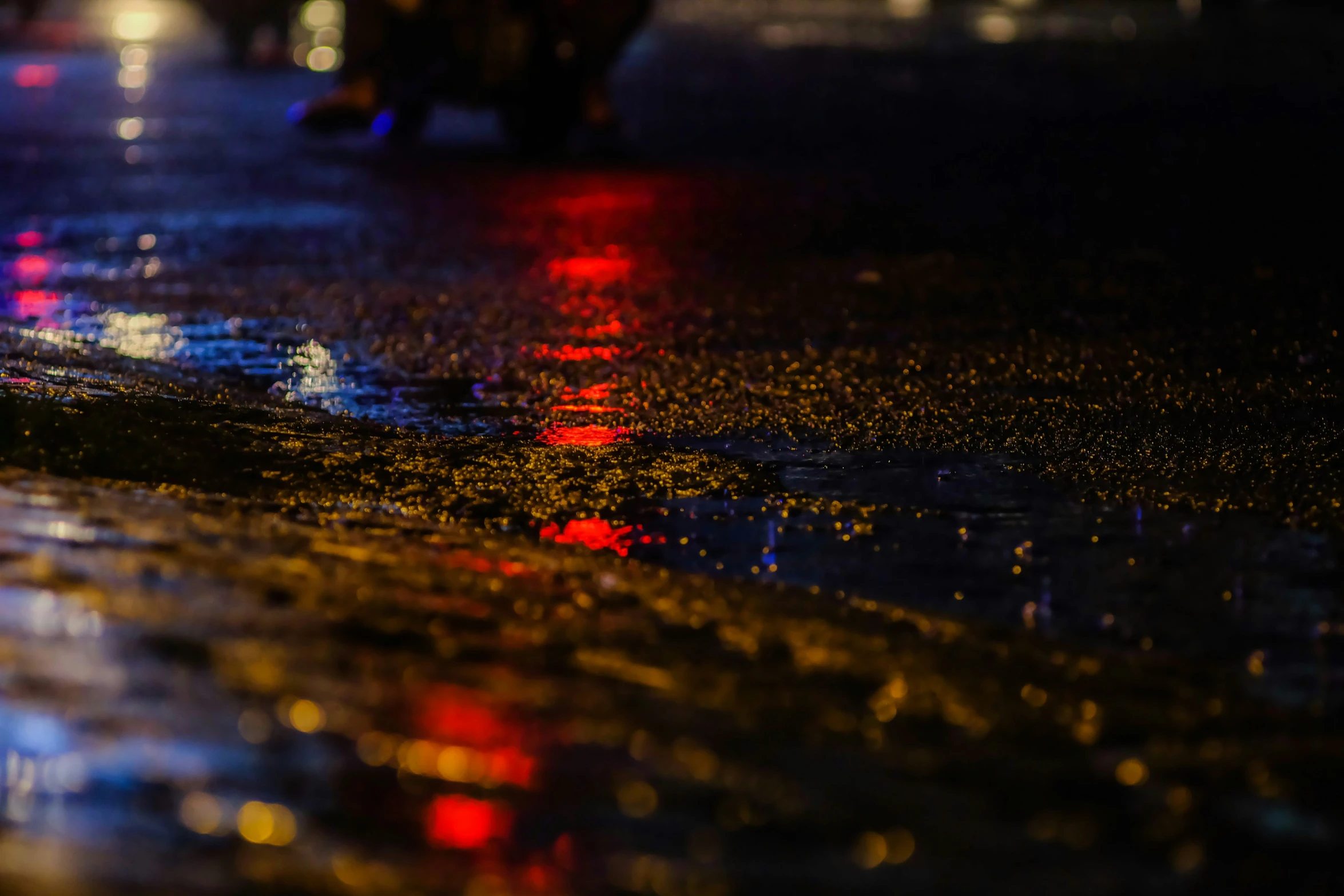 some colorful lights on the road in the dark