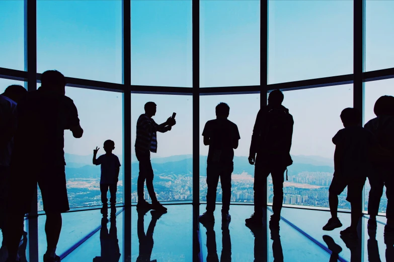 people standing in a tall building with a view