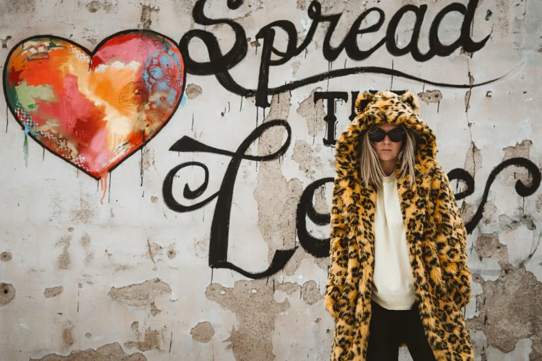 a man wearing a leopard print coat with hood