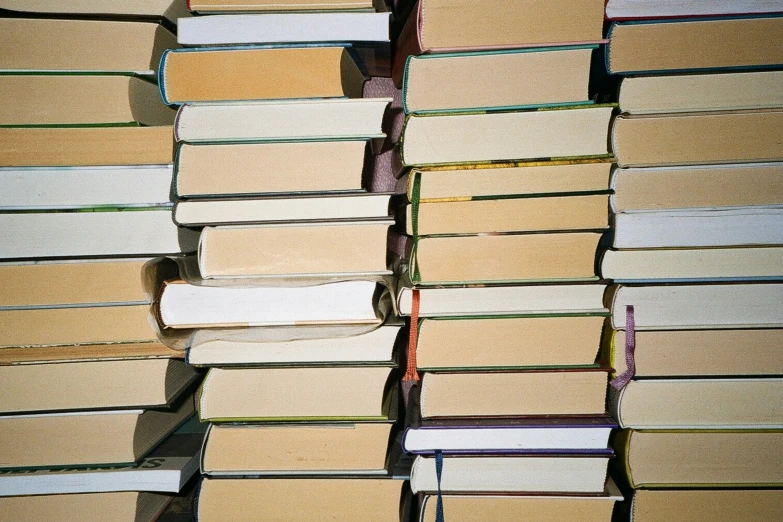 a huge stack of books on a table