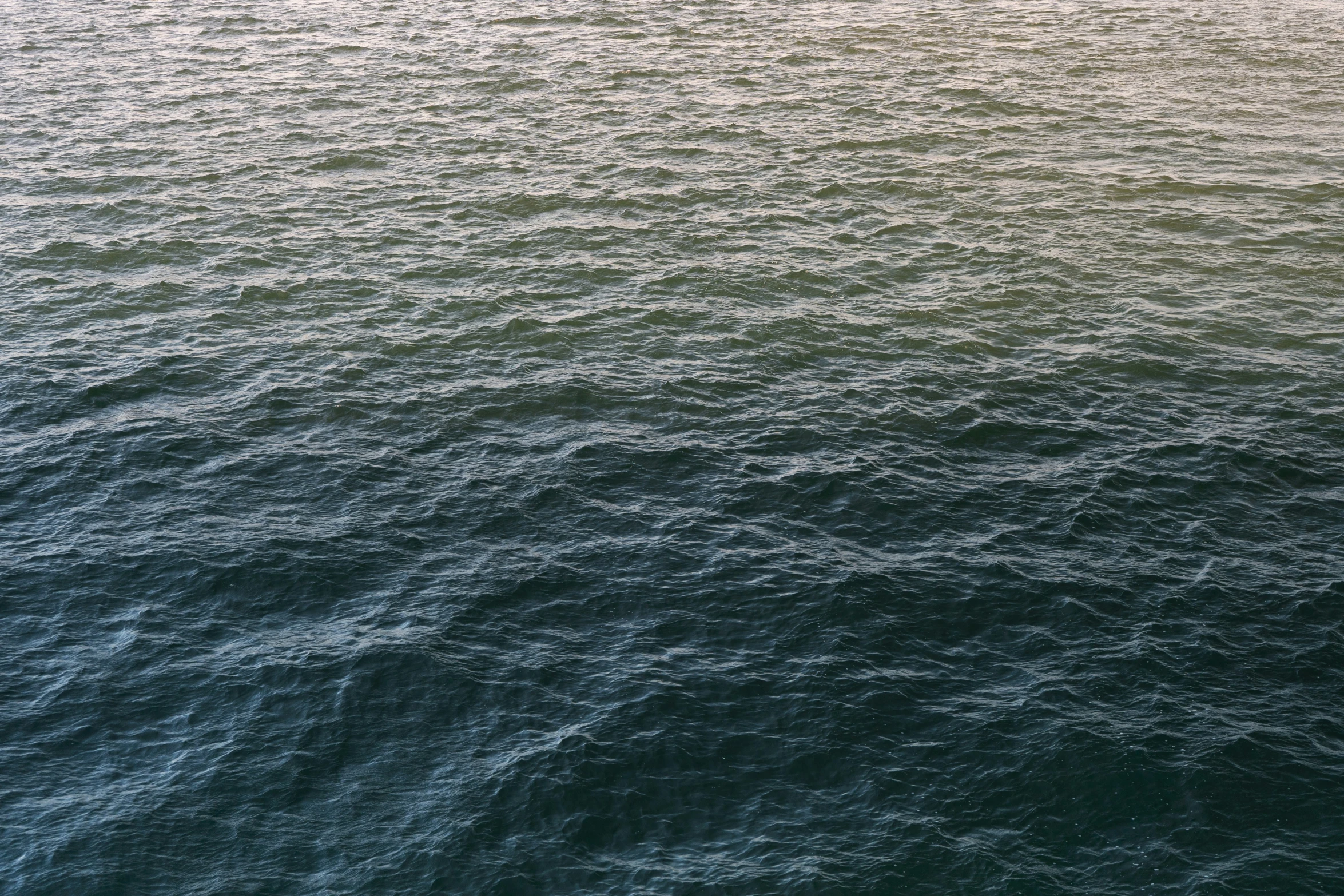 a lone boat in the middle of an ocean