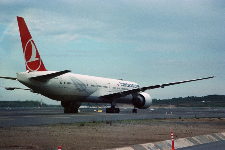 an airplane is at the airport runway during the day