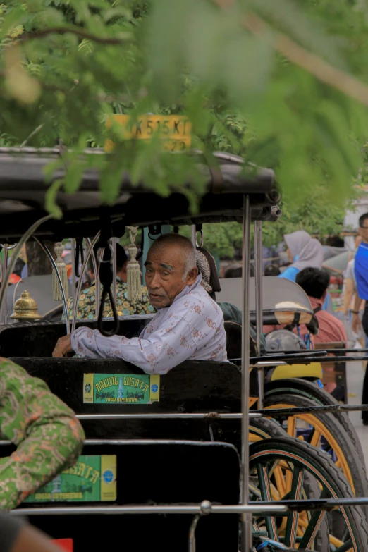 the old man is driving the cart with some toys