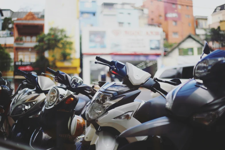 many different motorcycles are lined up outside in the street