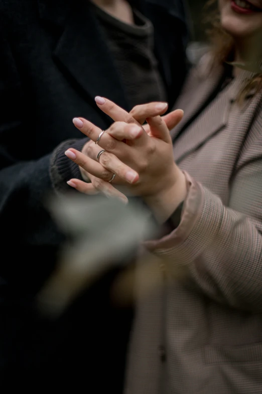 a couple of people holding hands in the rain