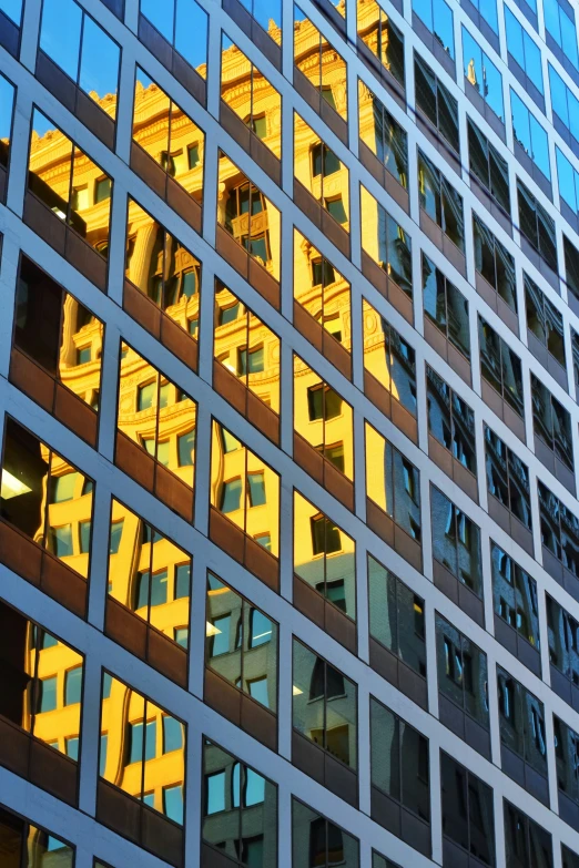 a reflection of a building in a glass facade