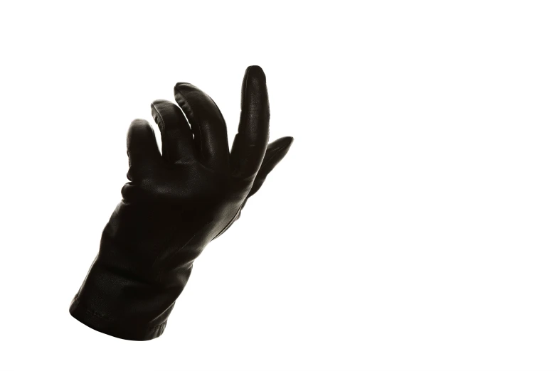 a black glove is shown with one hand extended and the other thumb down