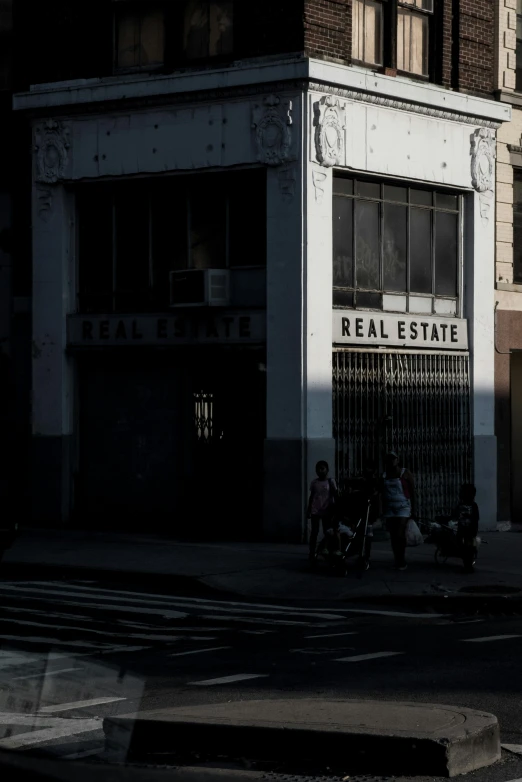 two people are walking in front of the building