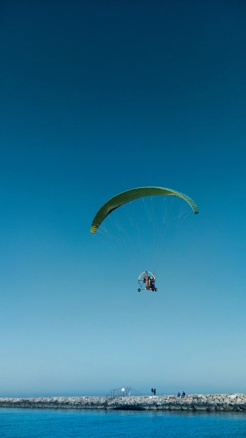 a man riding in the air on top of a para sail