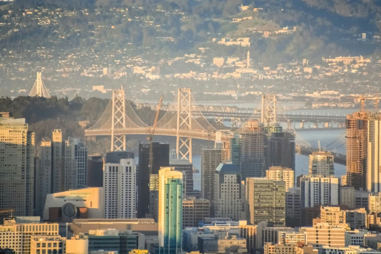 an aerial view of a city with buildings and bridges in the background