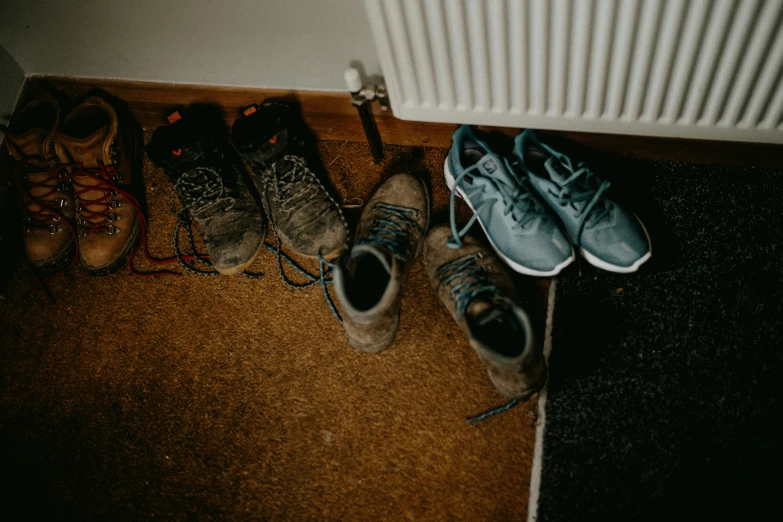a group of shoes are lined up against a wall