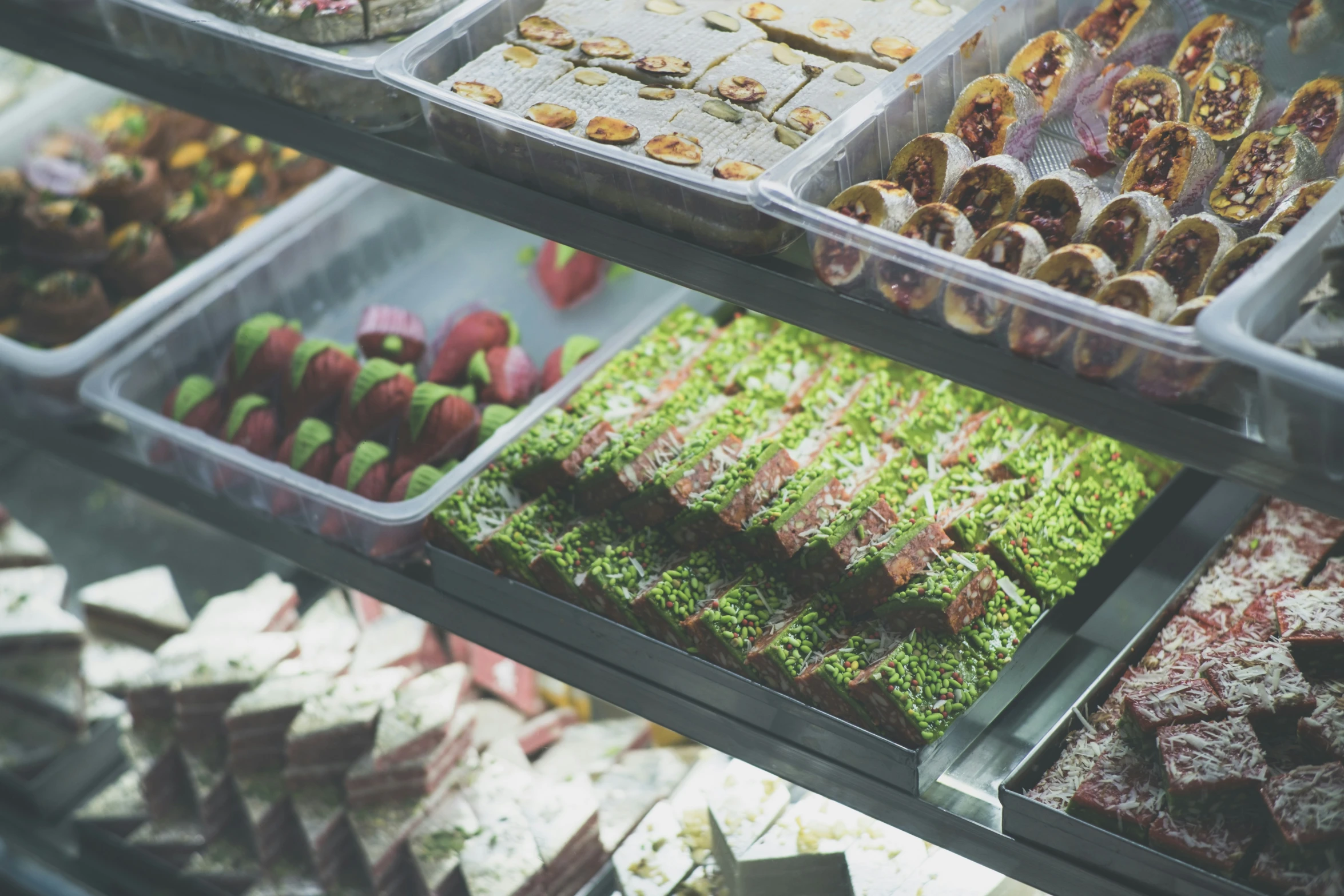 a close up of a display with many desserts