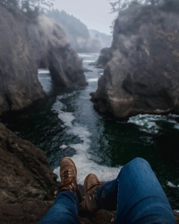 a person laying down looking out at the water