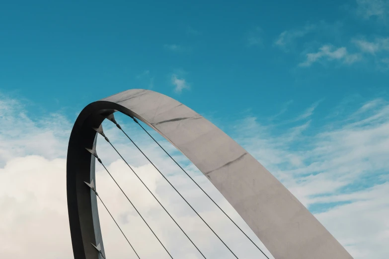 a very long curved metal arch on the side of a building