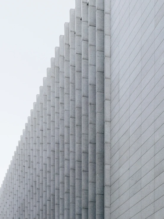 a line of concrete dividers against a gray concrete wall