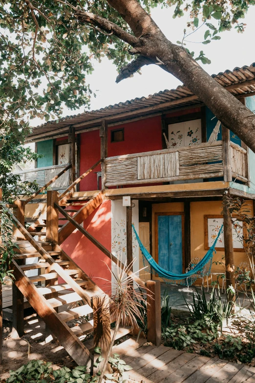 a wooden deck with a blue hammock hanging over it