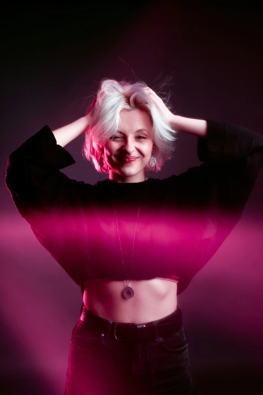 a young woman is shown in front of pink light