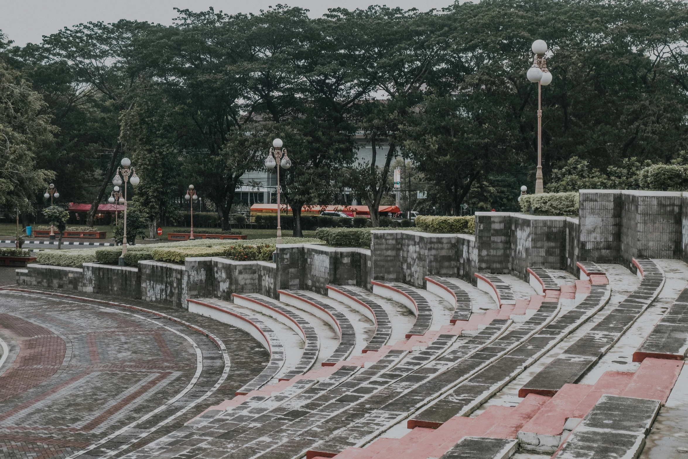 this is an old picture of a city with cement walls and street lamps