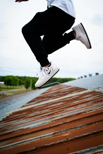 a man jumping high into the air on top of a wooden floor
