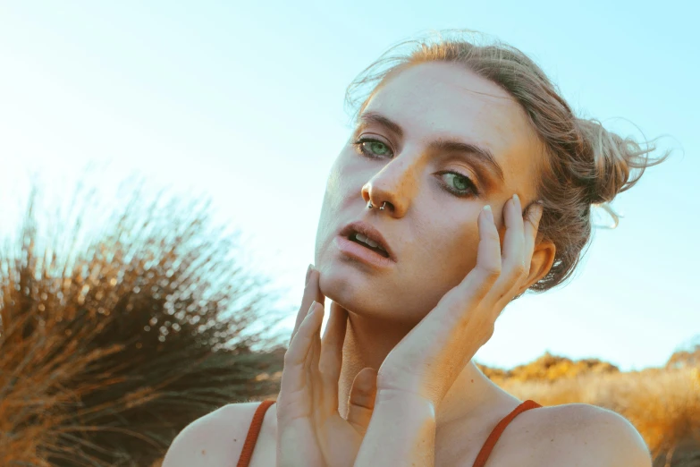 a woman with freckles on her face with palm trees in the background