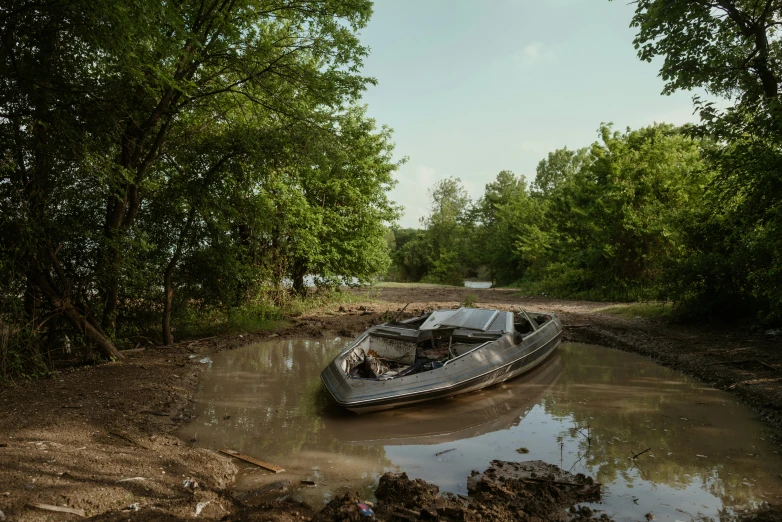 a boat tied to a dock in a ditch