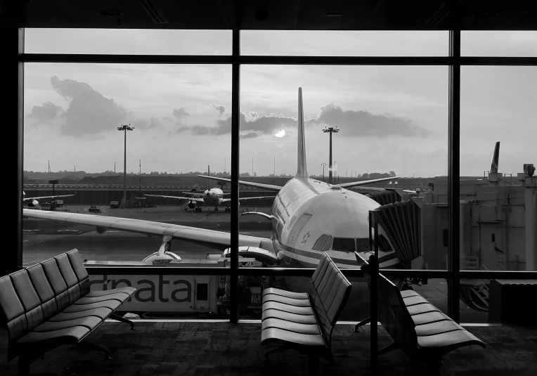 a view of the airplanes from a window in an airport