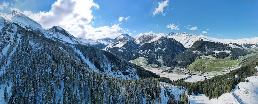 snowy mountains are seen from a viewpoint with the sky above them
