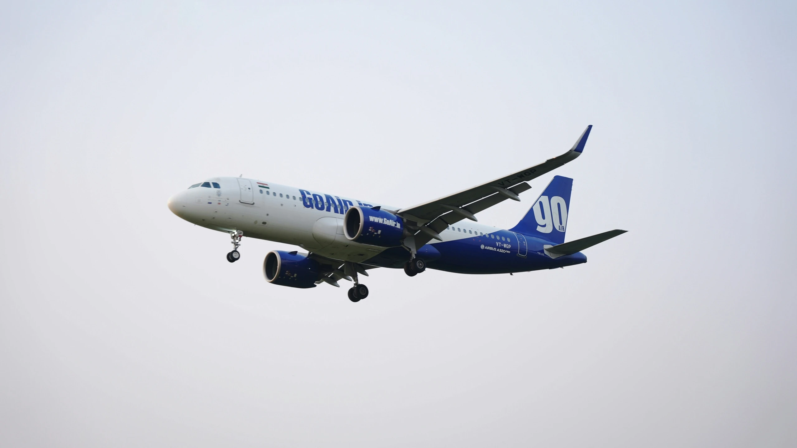 large airplane flies overhead on clear day