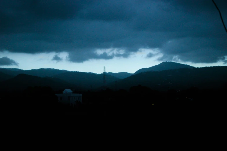 a dark sky with trees on both sides of it