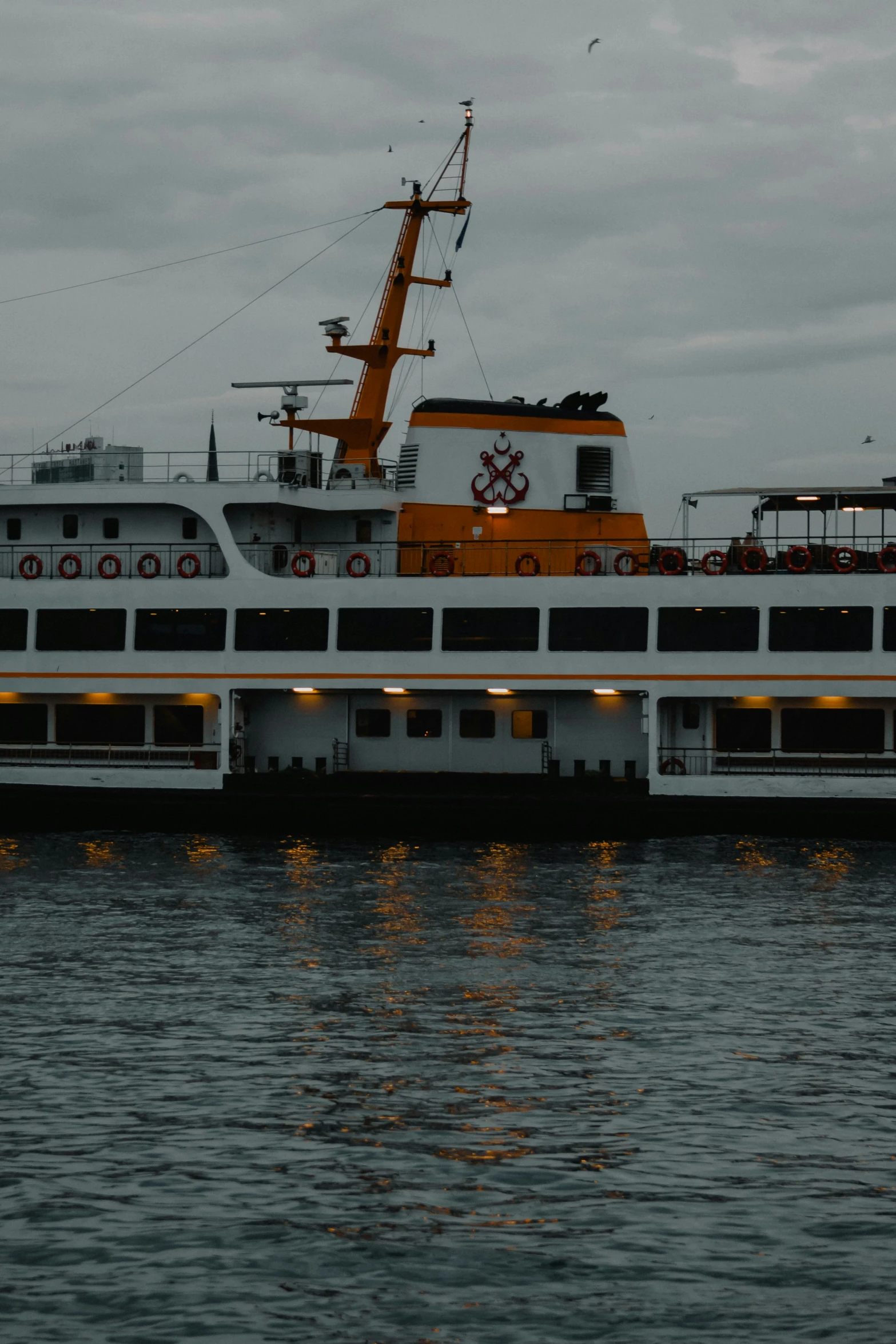 a white and orange ferry boat on the water