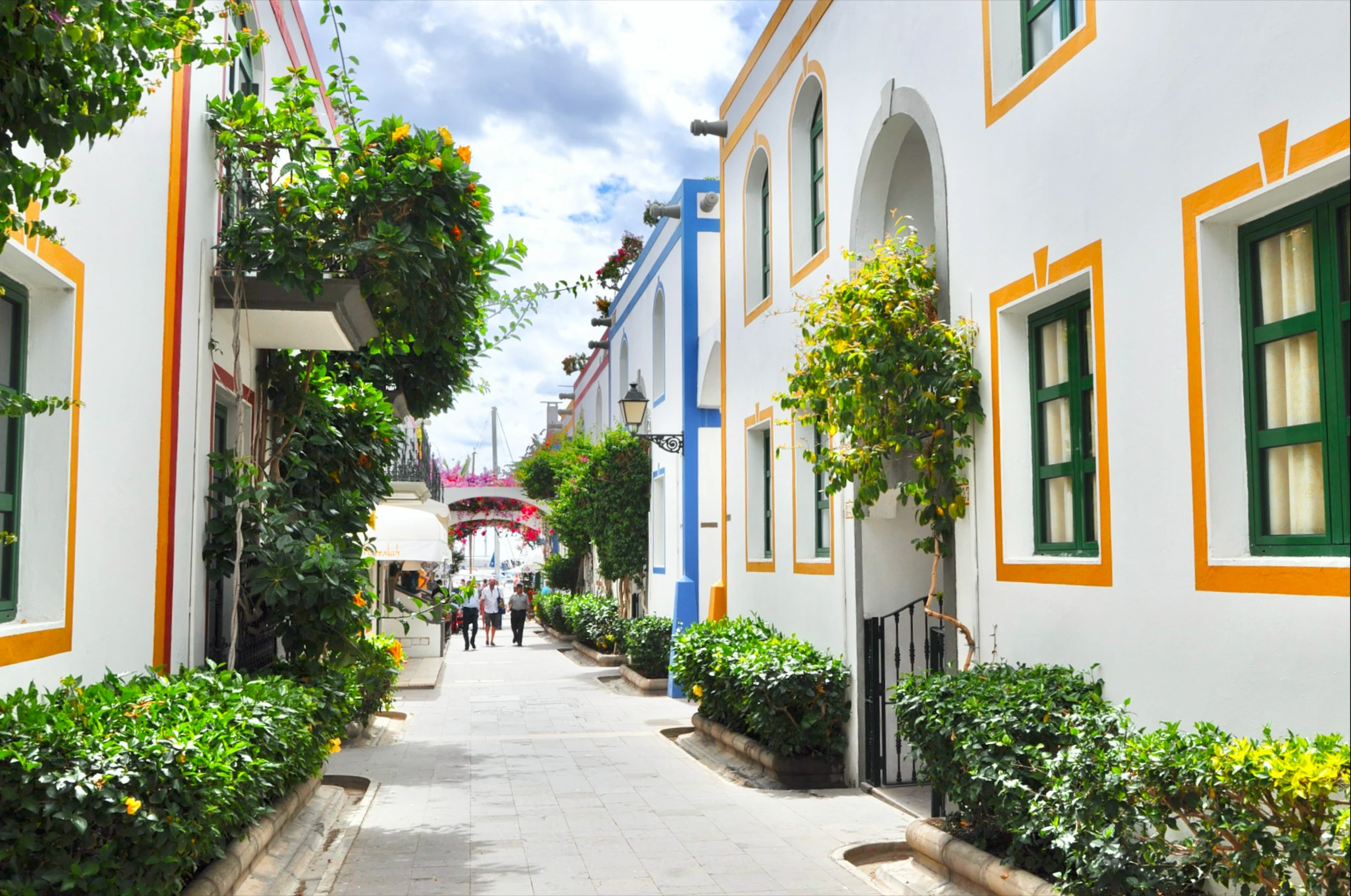 the walkway next to some colorful houses in a village