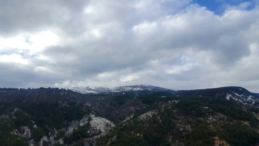 mountains covered with snow under cloudy skies