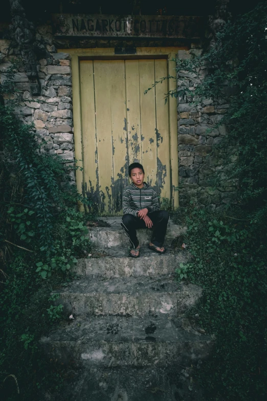 a man sitting on steps in front of a doorway