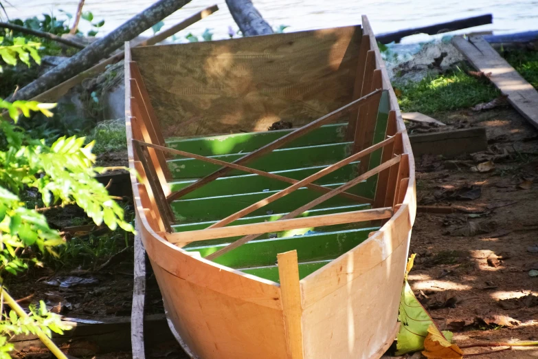 an old wooden boat parked in the dirt