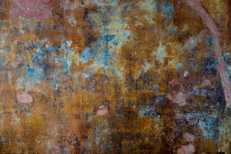 an old rusty metal surface that has a bunch of blue and orange rust