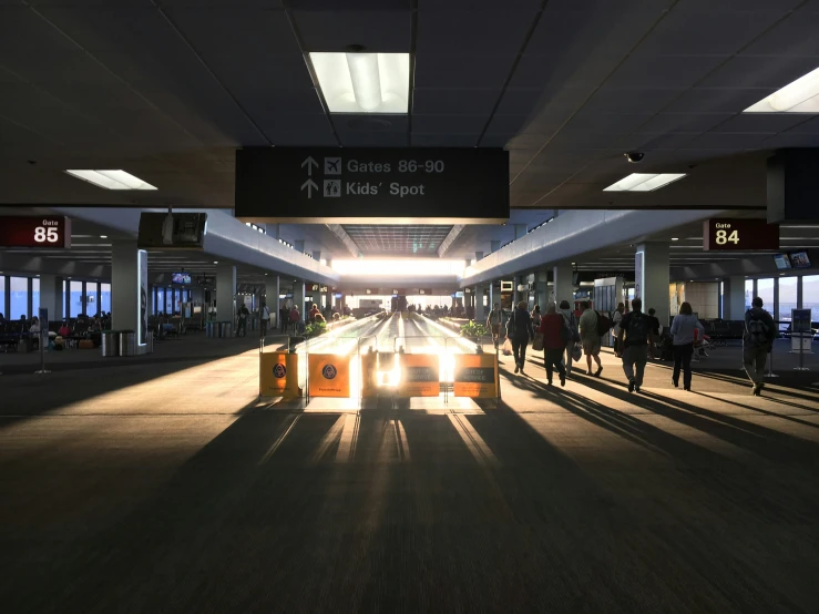 a train station filled with people next to terminal signs