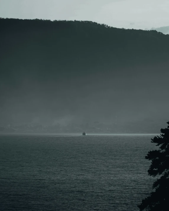 the view from across a bay is on a misty day