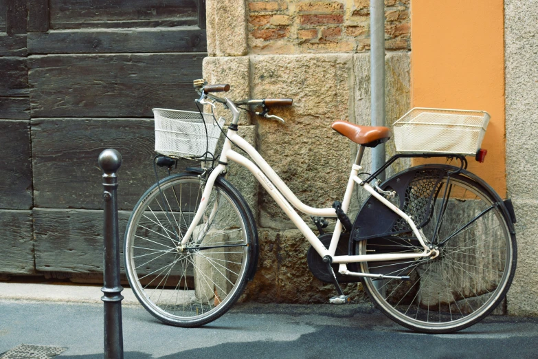 a bicycle parked near a lamppost on a sidewalk