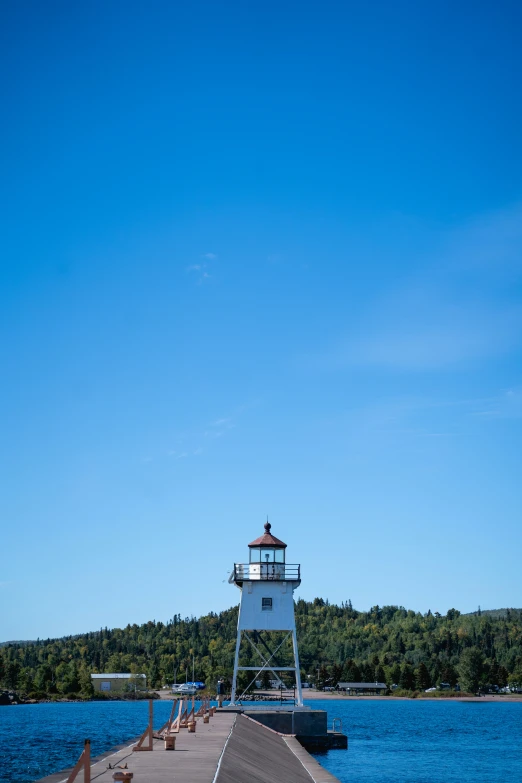 the lighthouse is near the shore of the water