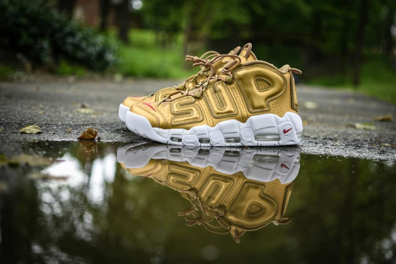 the reflection of an upper sneaker in water on asphalt