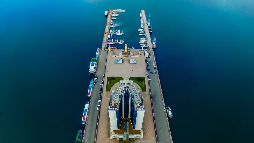 an aerial view of a large structure sitting on water