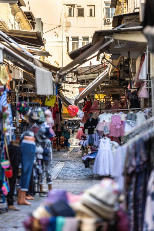 people shopping and standing around in an outdoor market