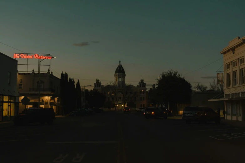 buildings and cars on a city street at night